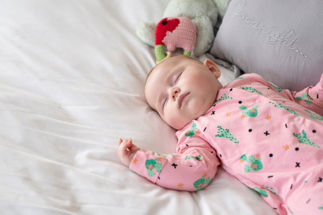 Parent with a giggling baby in a MyBabyGrow sleepsuit – Convenience and joy in one outfit."